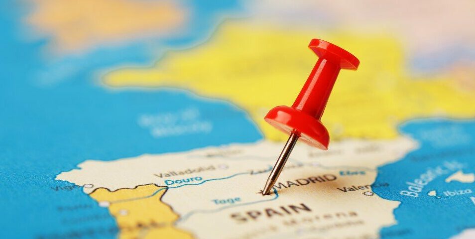 The location of the destination on the map of Spain is indicated by a red pushpin. Spain marked on the map with a red button